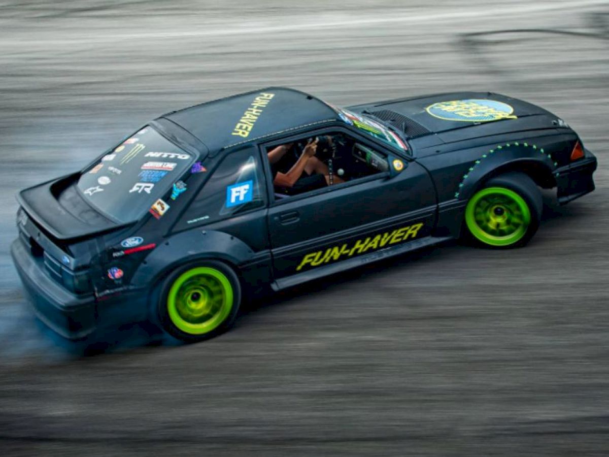 A black car with yellow and blue decals, including the text 